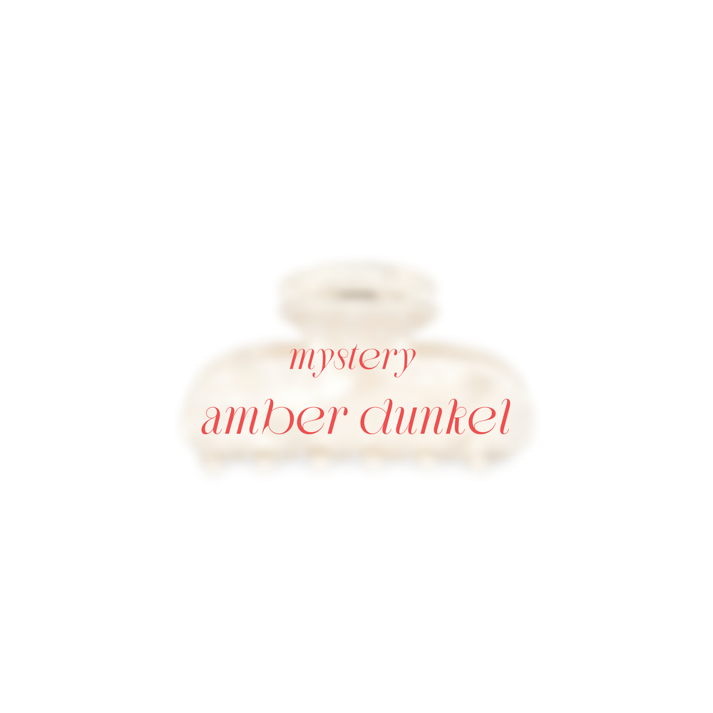 EIn Bild von der Amber Beige verschwommen mit dem Text in Rot Mystery Amber Dunkel.