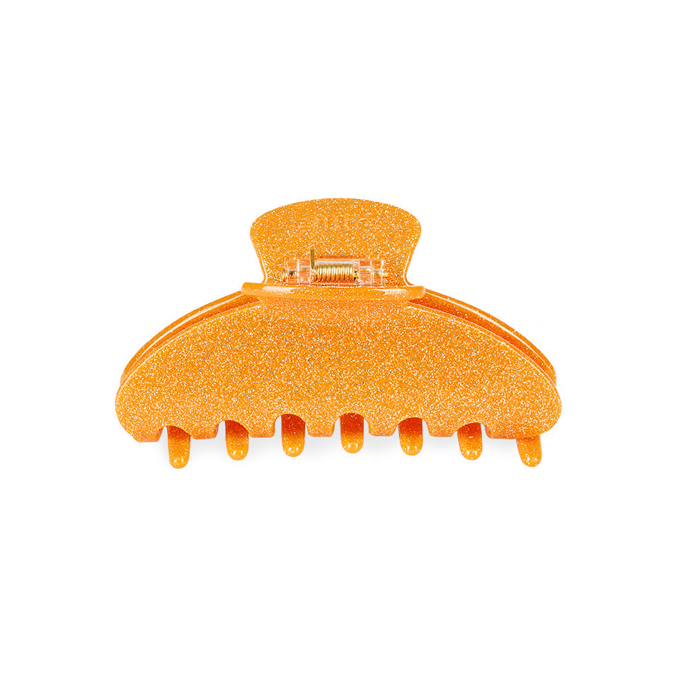 eine große Haarklammer in Orange Glitzer.